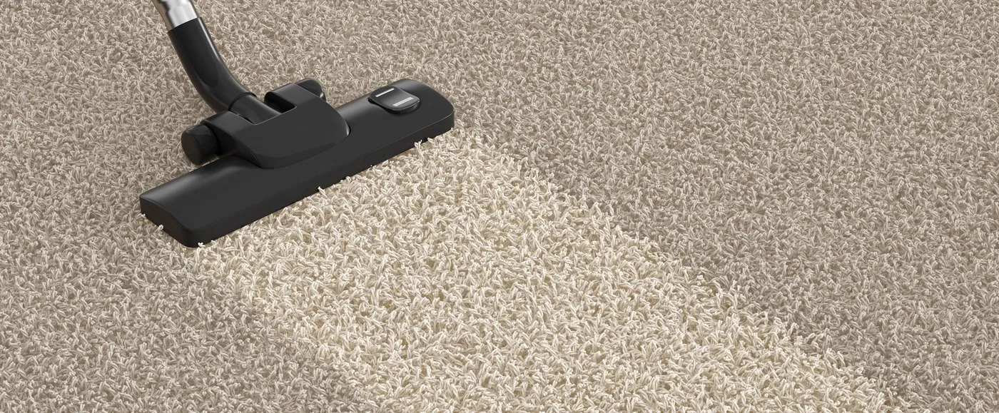 Vacuum leaving a clean, bright lane across beige carpet